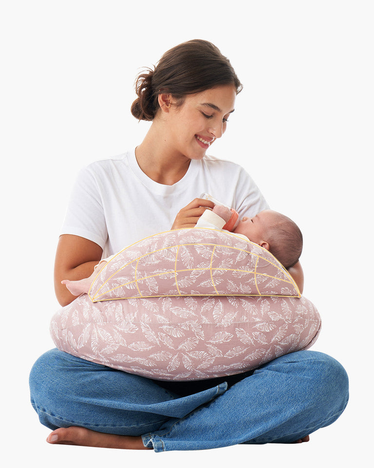 Translation missing: en.Mother uses multifunctional adjustable pink nursing pillow with feather pattern to feed baby